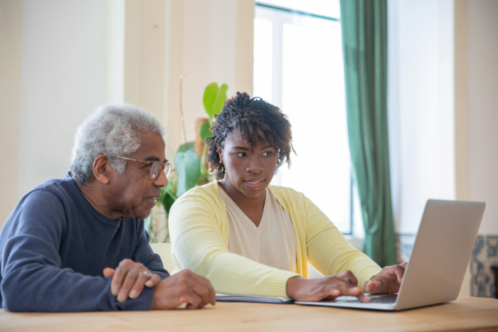 a daughter signing her father up for a high yield savings account for seniors in plaquemine