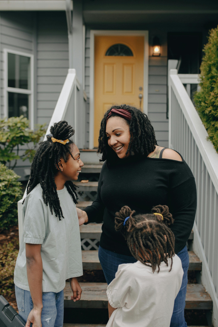 a mother and her 2 daughters outside of their home in houston
