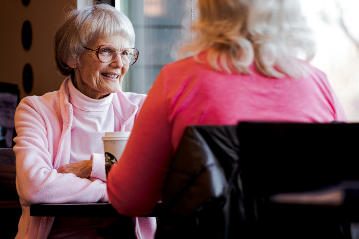 older women having coffee together idscussing senior savings accoutns in walker la